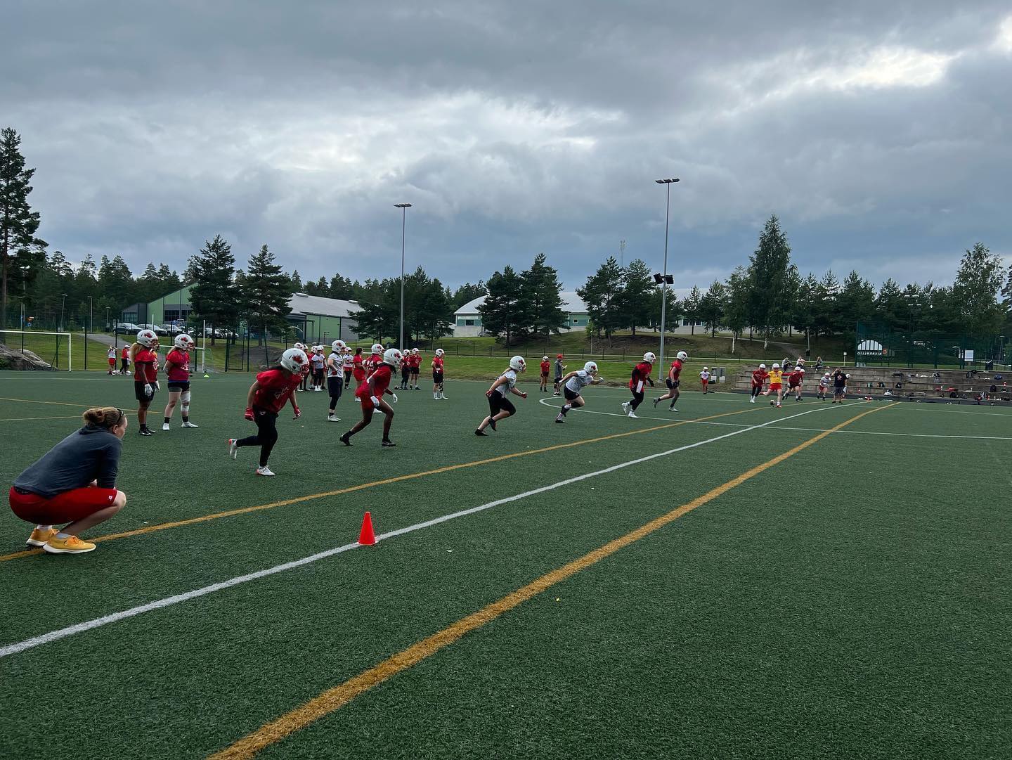 Claire Dore (BSKI'02) coaches the wide receivers at a Team Canada practice. (photo submitted)
