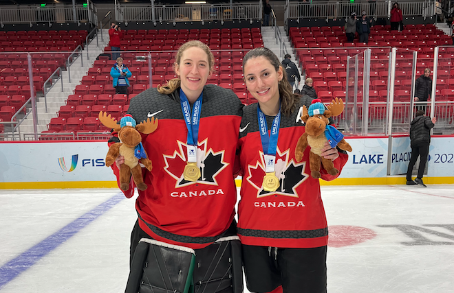 Camryn Drever (left) and Isabella Pozzi (right) show off their gold medals from the FISU World University Winter Games. (Rich Abney/Huskie Athletics)