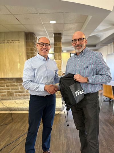 Cary Primeau, Interim Director of USask Rec, presents Paul Rogal with a gift on behalf of USask Rec.